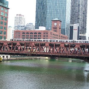 A CTA train crosses a green Chicago River