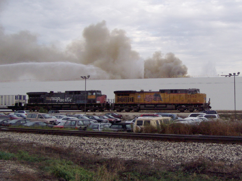 UP 5562 passes a raging warehouse fire